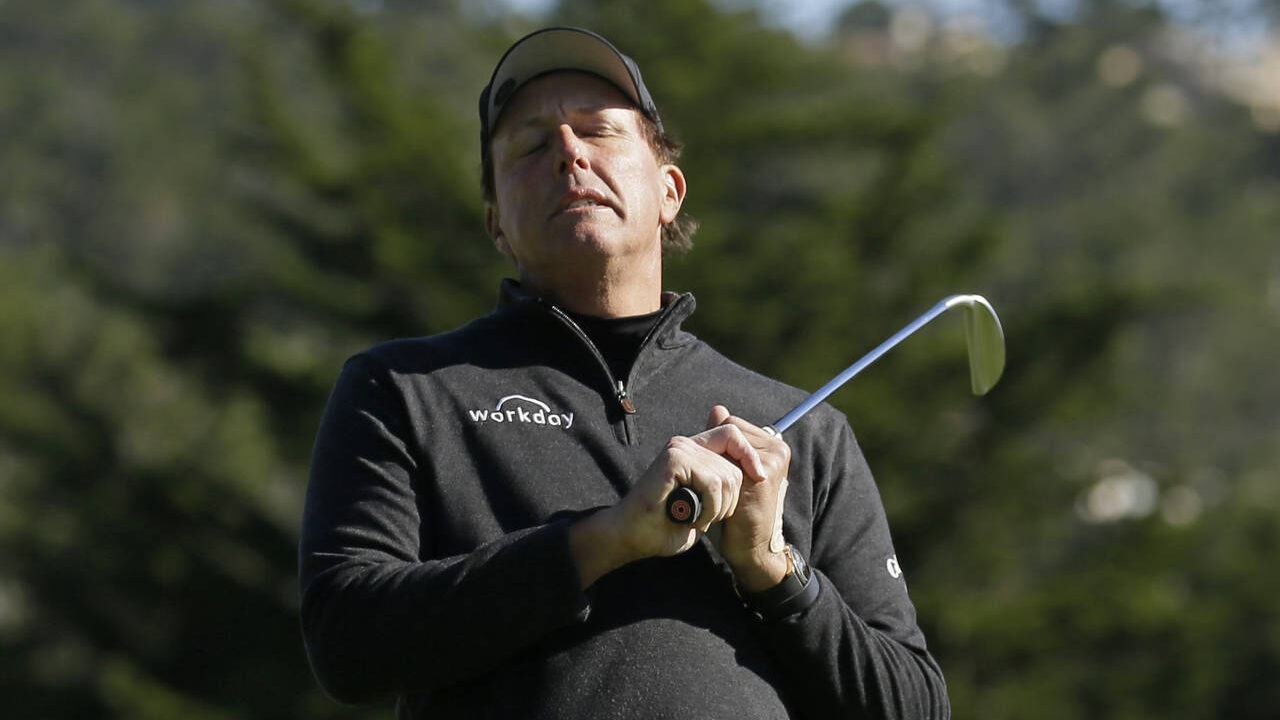 Phil Mickelson reacts after missing a birdie putt on the third green of the Pebble Beach Golf Links...