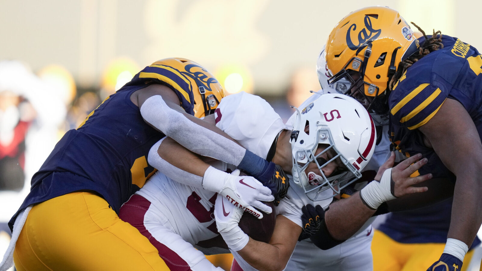 Stanford running back Mitch Leigber, middle, runs the ball against California during the first half...