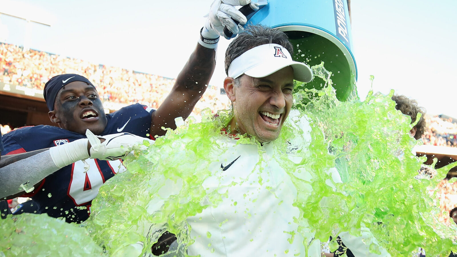 Head coach Jedd Fisch of the Arizona Wildcats is dunked with Powerade after defeating the Arizona S...