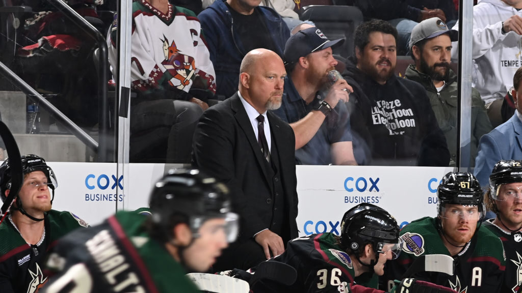 Head coach Andre Tourigny of the Arizona Coyotes looks on from the bench against the Seattle Kraken...