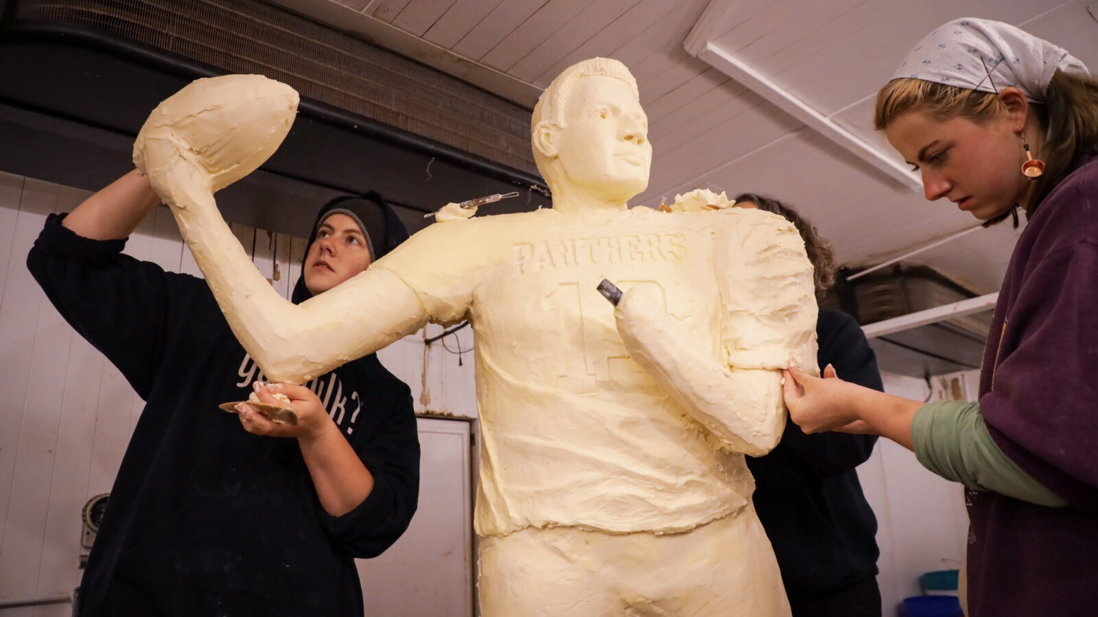 Workers attempt to sculpt a figure of former Arizona Cardinal and Pro Football Hall of Famer Kurt W...